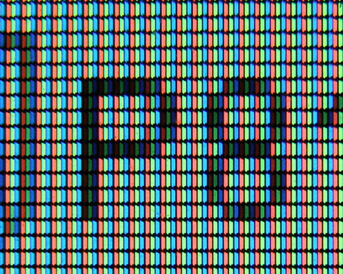 Closeup view of computer monitor pixels, with R, G and B parts.